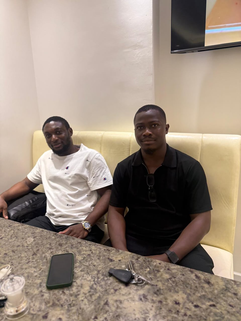 Two friends seated together at a table